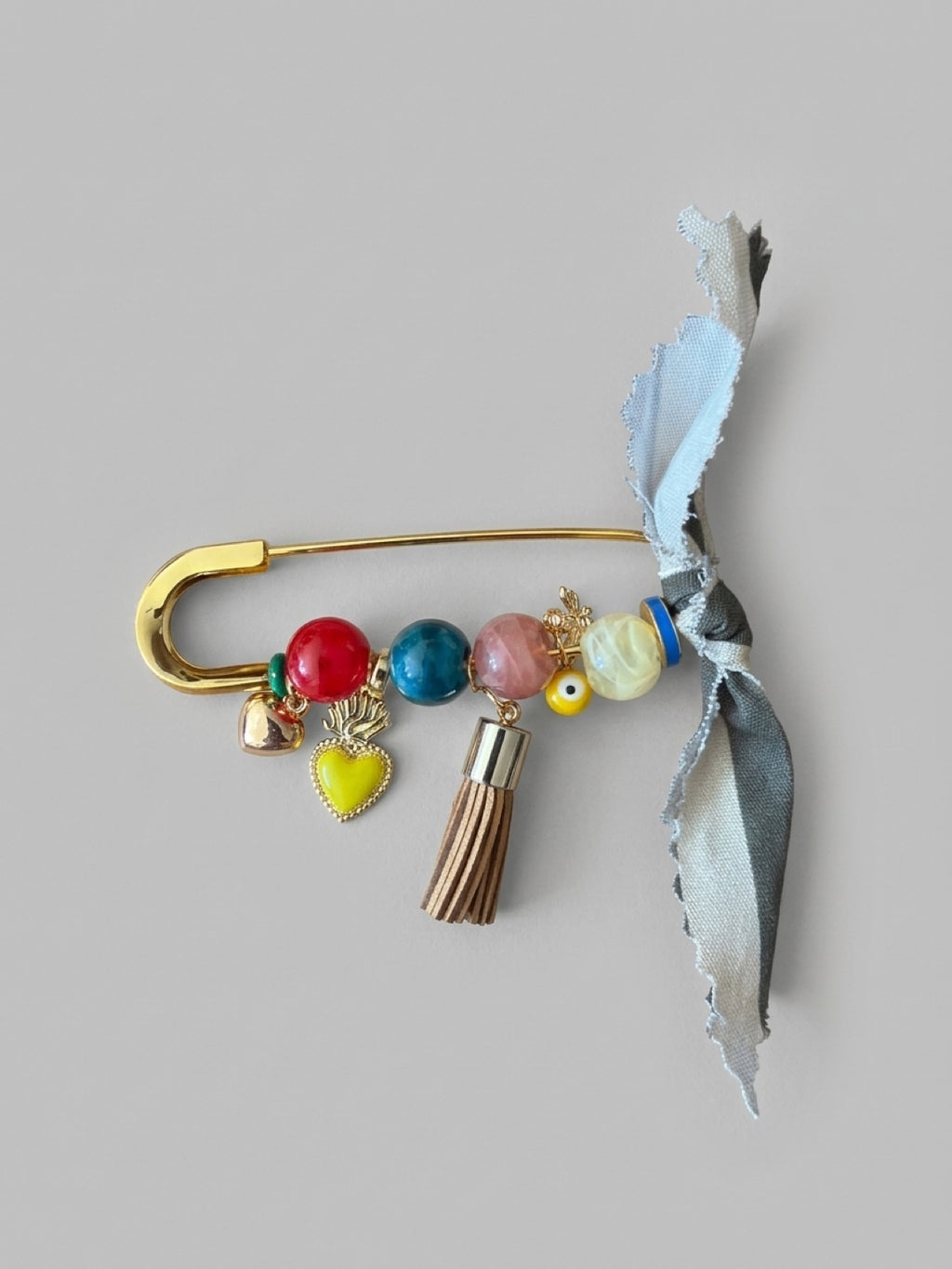 Handcrafted Gemstone & Charm Statement Pin with Tassel and Bow Accent